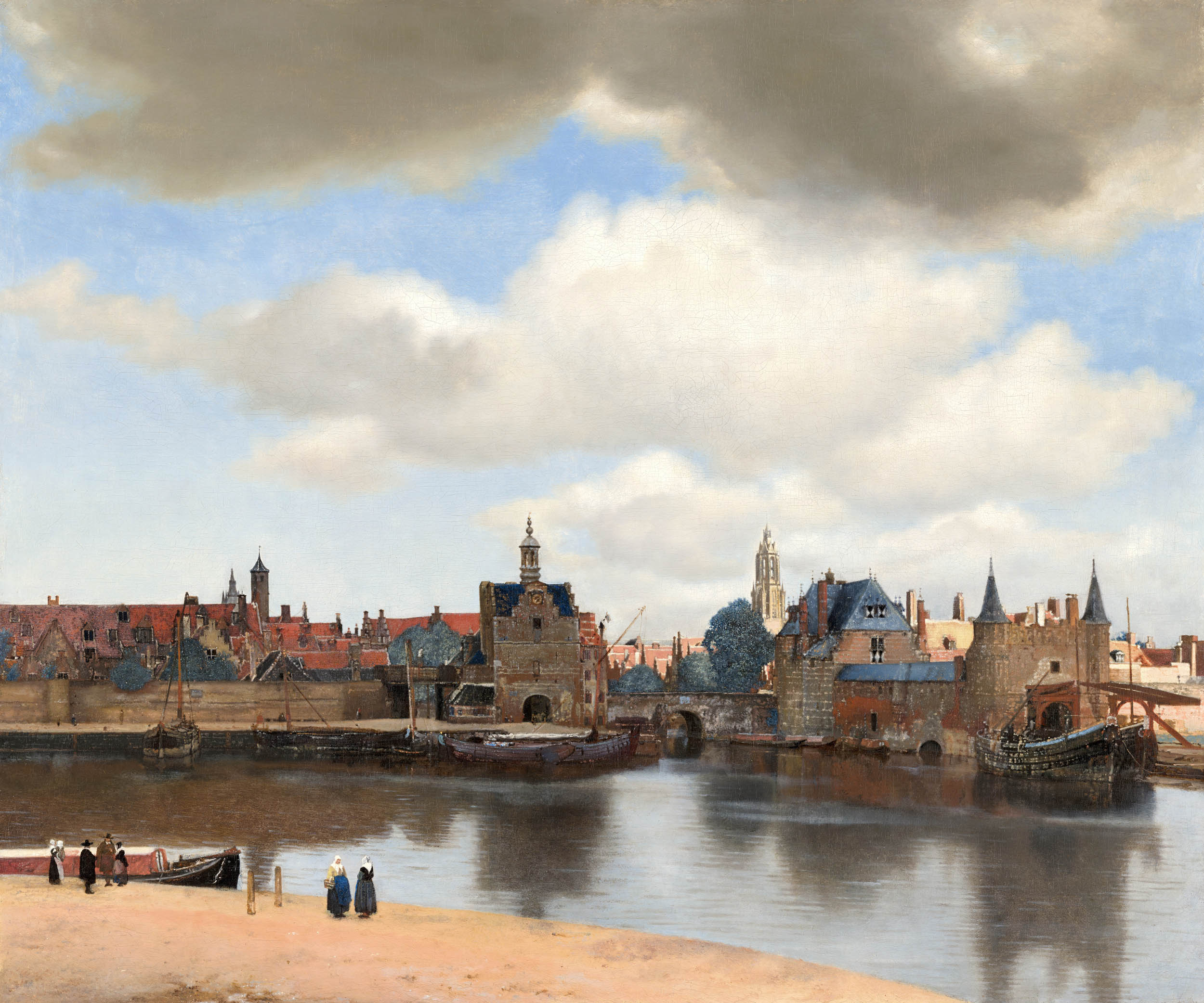 Veduta di Delft di Johannes Vermeer, panorama della città con porto, edifici, barche e un ampio cielo nuvoloso riflesso nell’acqua.